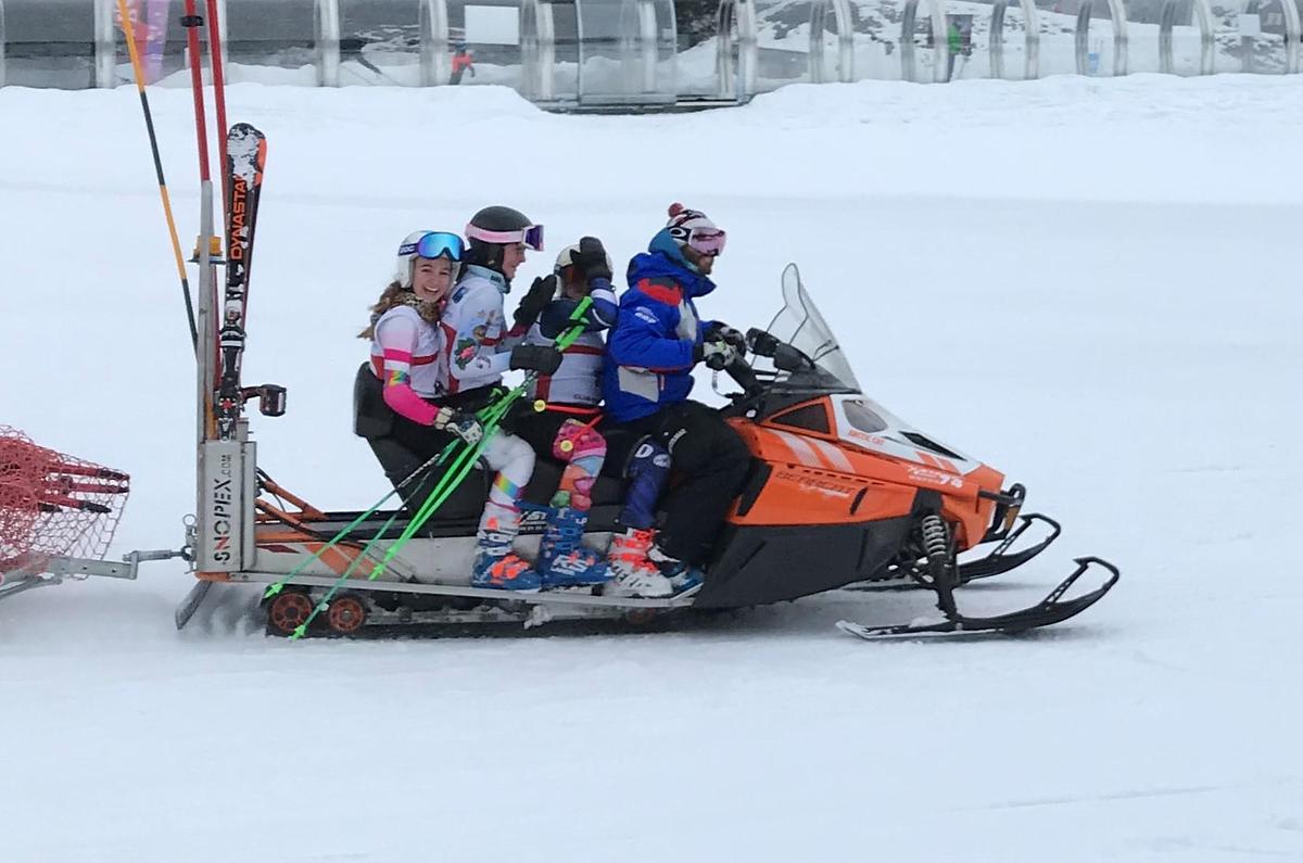 Ski team on a snowmobile